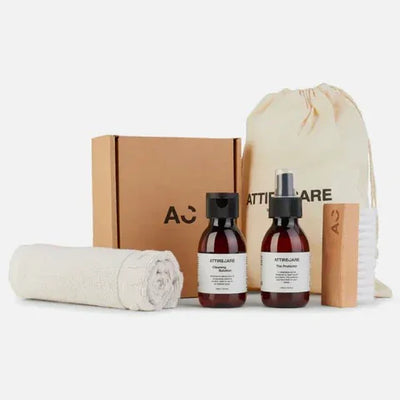 AttireCare luxury garment care kit with cleaning solution, spray, brush, towel, and storage bag