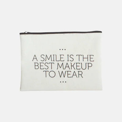 White makeup bag with quote 'A smile is the best makeup to wear' — eco-friendly luxury accessory