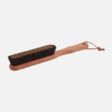 Wooden brush with black bristles for garment care, eco-friendly dry cleaning accessory