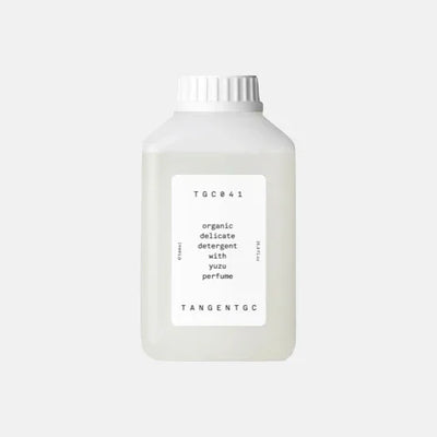 Organic delicate detergent with yuzu perfume in minimalist white bottle, eco-friendly garment care