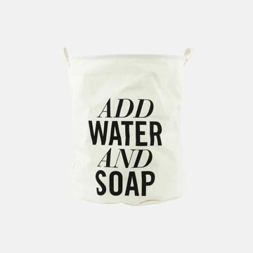 Cream laundry bag with bold black text 'ADD WATER AND SOAP' for eco-friendly garment care