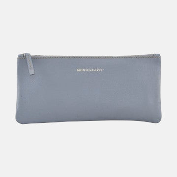 Light gray leather pouch with monogram detail, minimalist design for luxury garment care essentials