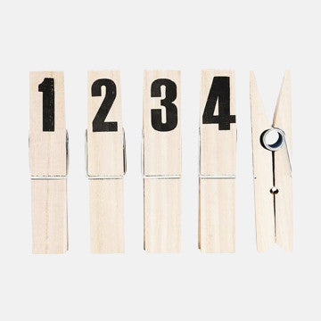 Wooden clothespins numbered 1 to 4 with one open, clean minimalist design