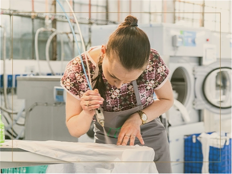 Finished garments on the rail at the Blanc atelier